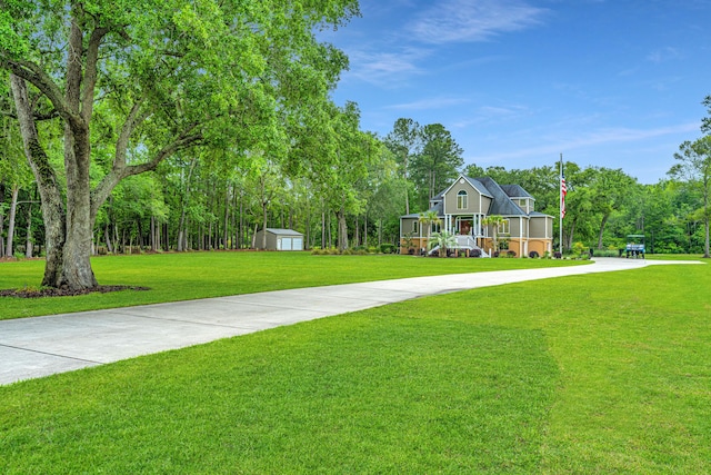 view of property's community featuring a storage unit and a lawn