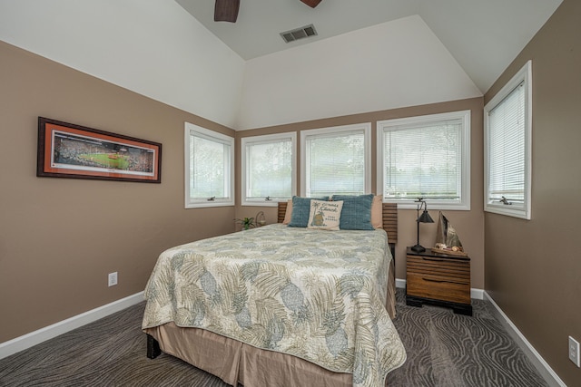 bedroom with dark colored carpet, vaulted ceiling, and ceiling fan