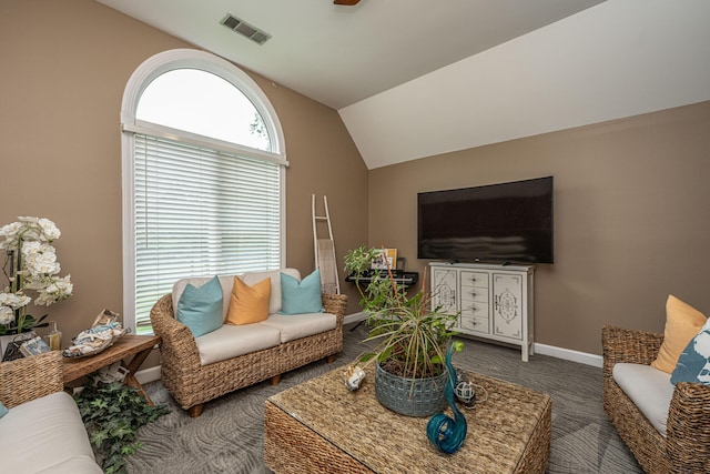 carpeted living room featuring lofted ceiling