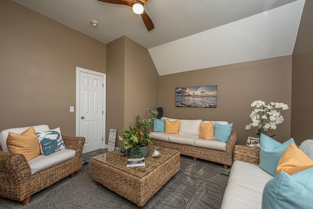 living room featuring ceiling fan, carpet flooring, and vaulted ceiling