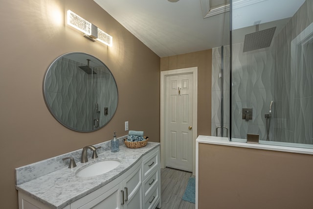 bathroom featuring vanity, hardwood / wood-style flooring, and a shower with shower door