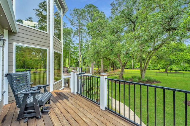 wooden terrace featuring a yard