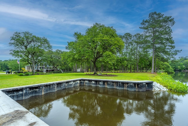 exterior space featuring a water view and a lawn