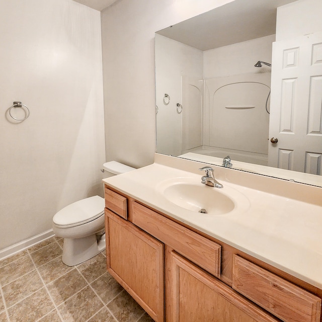 bathroom with walk in shower, vanity, toilet, and tile patterned floors