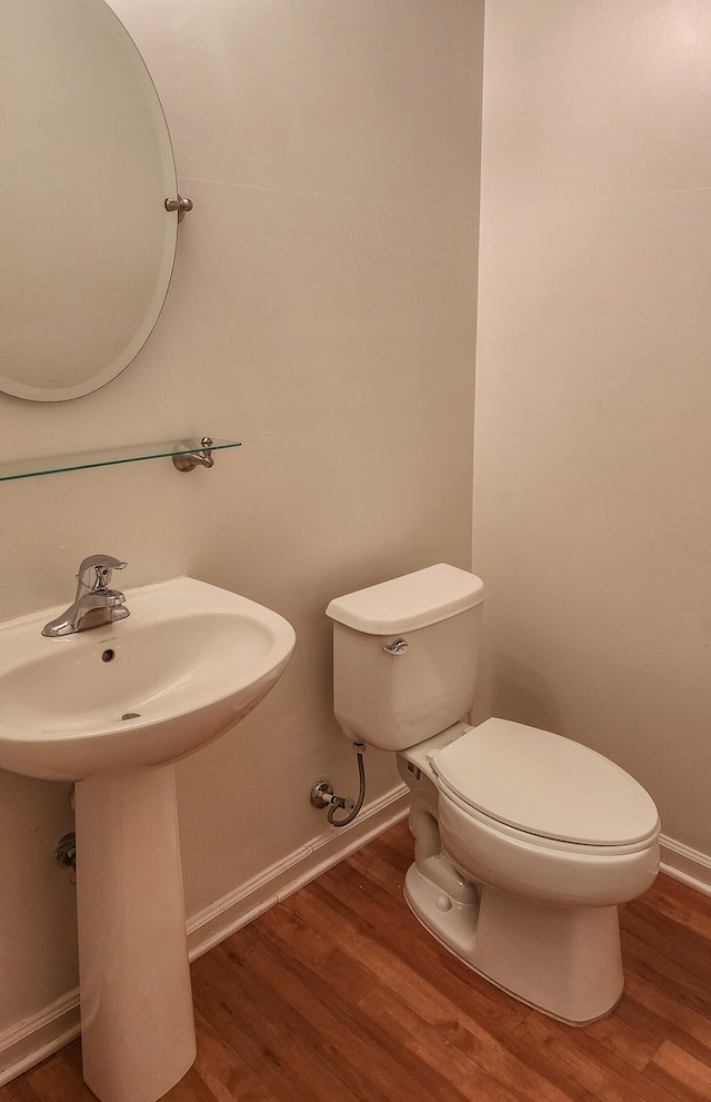 bathroom with wood-type flooring and toilet