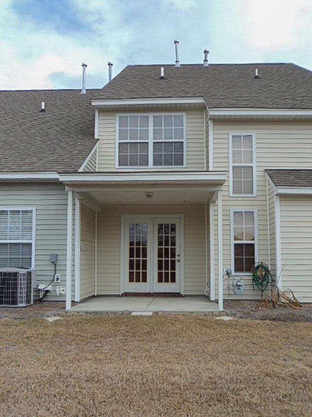 rear view of property with a patio area and central AC