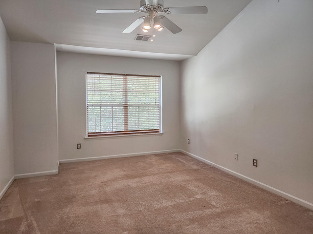 carpeted spare room featuring ceiling fan