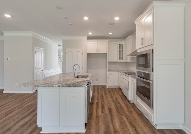 kitchen featuring an island with sink, appliances with stainless steel finishes, dark hardwood / wood-style flooring, and white cabinetry