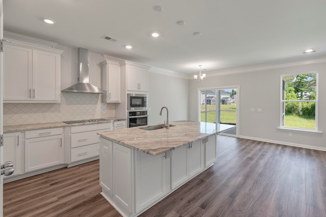 kitchen with white cabinetry, sink, wall chimney range hood, and stainless steel appliances