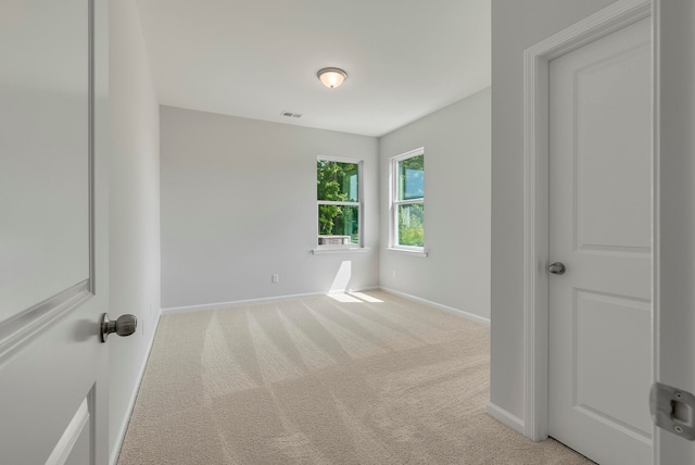 empty room featuring light carpet