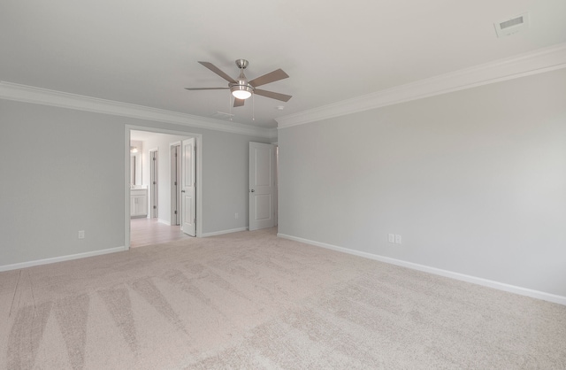 carpeted spare room featuring ornamental molding and ceiling fan