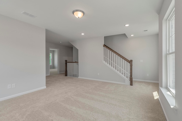 unfurnished room with light colored carpet