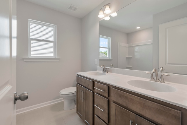 bathroom featuring vanity, toilet, and tile patterned floors