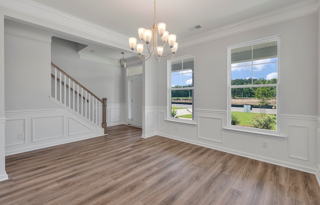 interior space featuring a notable chandelier, crown molding, and hardwood / wood-style flooring