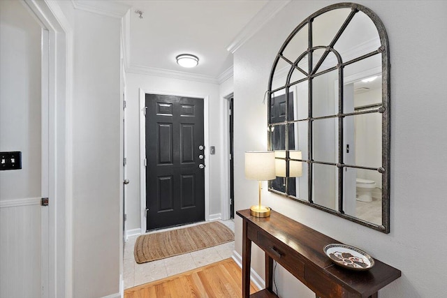 entryway featuring crown molding and hardwood / wood-style flooring