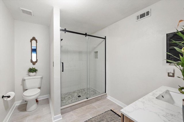 bathroom featuring vanity, toilet, and a shower with door