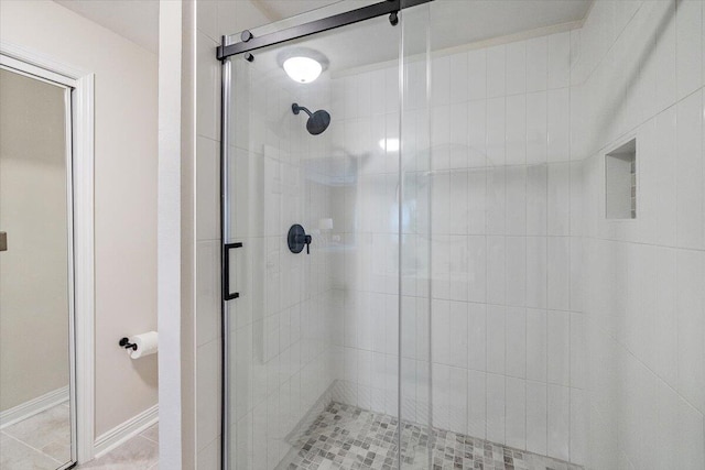 bathroom with tile patterned floors and an enclosed shower