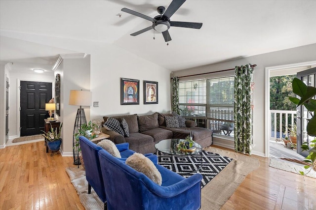 living room featuring light hardwood / wood-style flooring, lofted ceiling, plenty of natural light, and ceiling fan