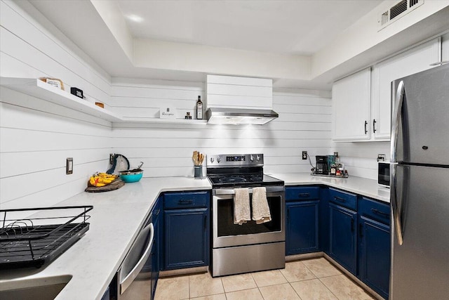 kitchen featuring blue cabinetry, appliances with stainless steel finishes, exhaust hood, and white cabinets