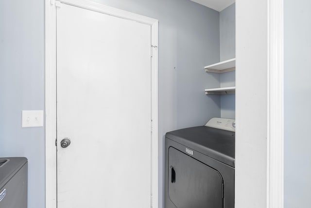 washroom featuring laundry area and washing machine and clothes dryer