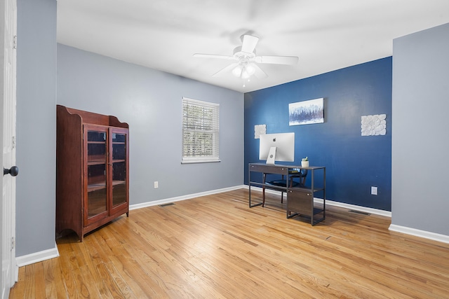 office area with wood-type flooring, baseboards, and a ceiling fan