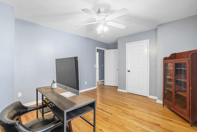 office with light wood-type flooring, ceiling fan, and baseboards