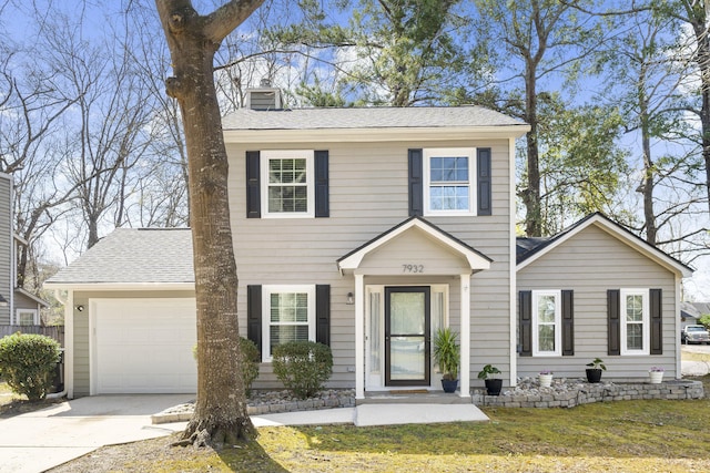 colonial inspired home featuring a garage, a shingled roof, driveway, a front lawn, and a chimney