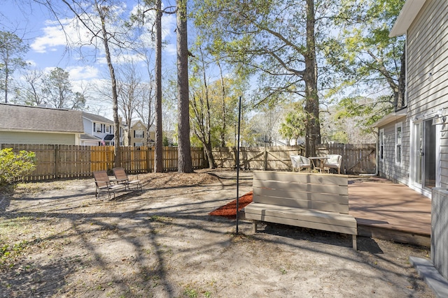 view of yard with a fenced backyard and a wooden deck