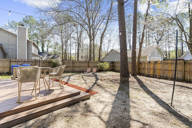 view of yard featuring a fenced backyard and a deck