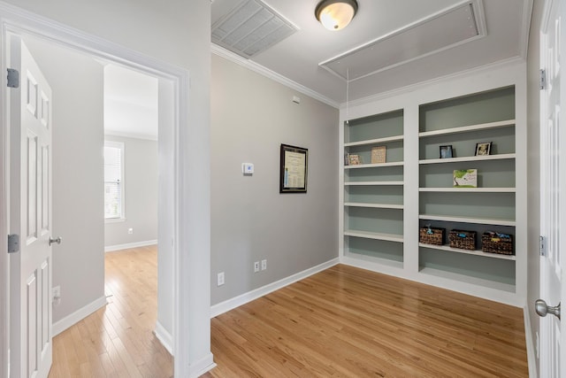 167 Palm Cove Way, Mount Pleasant, SC 29466 - unfurnished room with attic access, light wood-style flooring, crown molding, and built in shelves