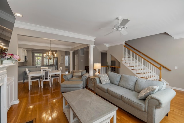 167 Palm Cove Way, Mount Pleasant, SC 29466 - living room featuring a ceiling fan, stairs, a chandelier, light wood-style flooring, and crown molding