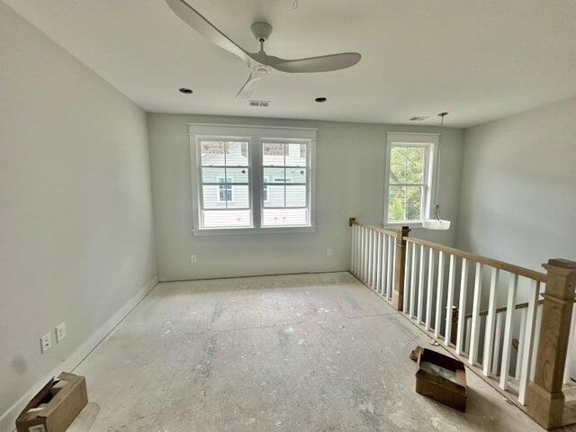 empty room featuring a ceiling fan and visible vents