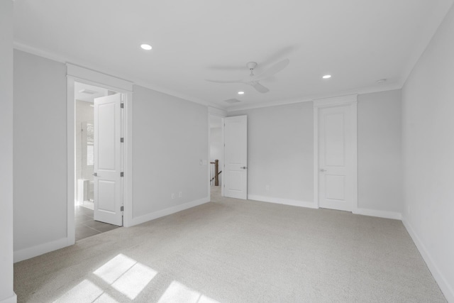 carpeted empty room featuring baseboards, ornamental molding, a ceiling fan, and recessed lighting