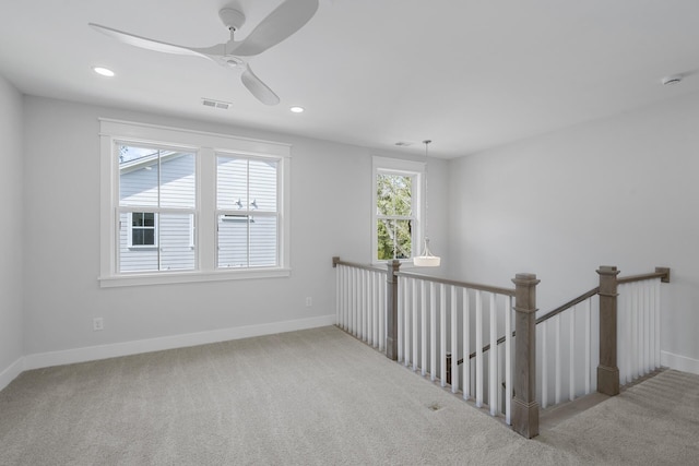 carpeted spare room with baseboards, visible vents, ceiling fan, and recessed lighting