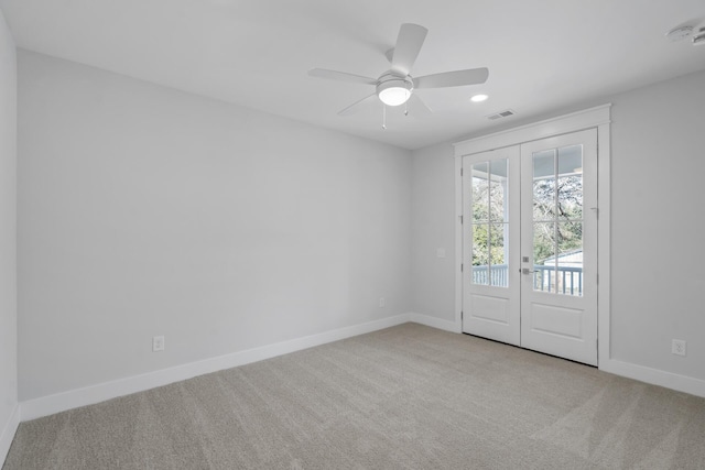 empty room with visible vents, baseboards, a ceiling fan, carpet, and french doors