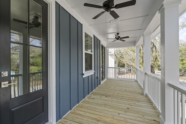 wooden deck with covered porch and a ceiling fan