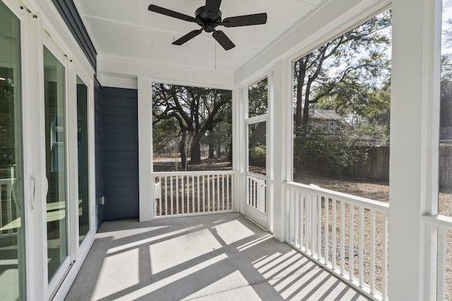 unfurnished sunroom featuring ceiling fan