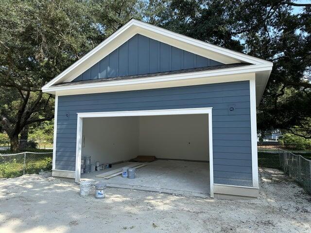 detached garage featuring fence