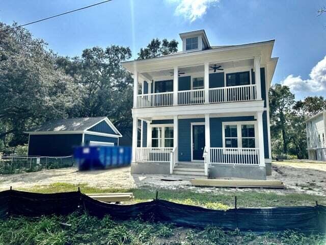 exterior space featuring a ceiling fan, covered porch, fence, and a balcony