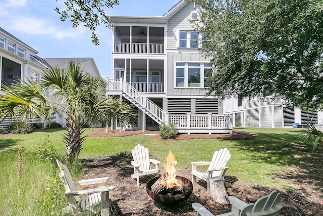 2072 Amenity Park Dr, Mount Pleasant, SC 29466 - back of house featuring a fire pit, board and batten siding, a lawn, a sunroom, and stairs