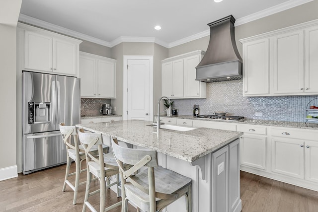 2072 Amenity Park Dr, Mount Pleasant, SC 29466 - kitchen with stainless steel appliances, premium range hood, a sink, an island with sink, and white cabinetry