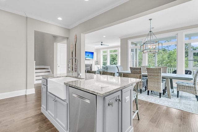 2072 Amenity Park Dr, Mount Pleasant, SC 29466 - kitchen featuring a sink, dishwasher, a glass covered fireplace, light wood-style flooring, and crown molding