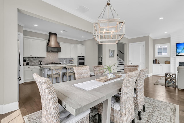 2072 Amenity Park Dr, Mount Pleasant, SC 29466 - dining space with a chandelier, ornamental molding, stairs, dark wood-type flooring, and baseboards