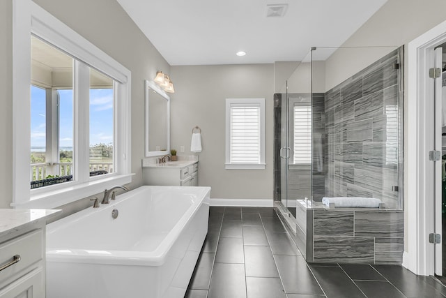 2072 Amenity Park Dr, Mount Pleasant, SC 29466 - bathroom with vanity, a freestanding tub, a stall shower, tile patterned floors, and baseboards