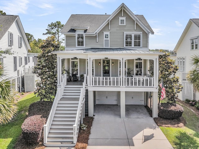 2072 Amenity Park Dr, Mount Pleasant, SC 29466 - coastal inspired home featuring a porch, stairs, a standing seam roof, a shingled roof, and concrete driveway