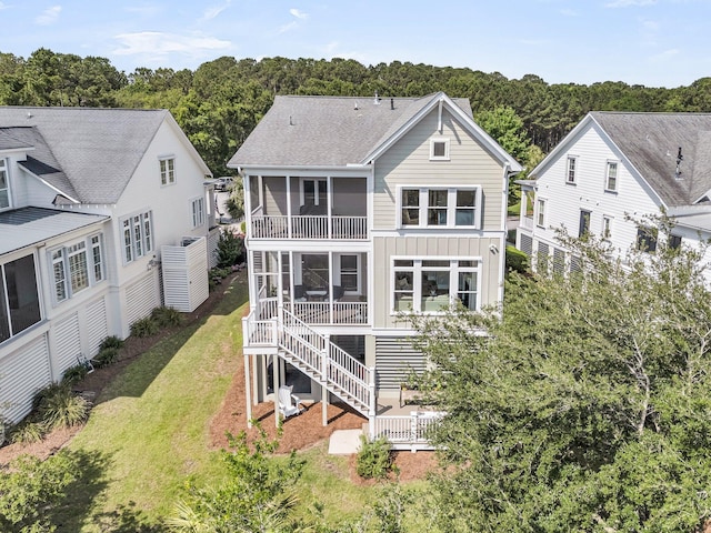 2072 Amenity Park Dr, Mount Pleasant, SC 29466 - back of property with a sunroom, board and batten siding, a yard, and roof with shingles