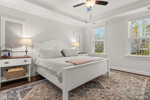 bedroom featuring ceiling fan, dark hardwood / wood-style floors, and crown molding