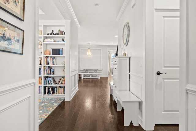 corridor with dark hardwood / wood-style floors and crown molding