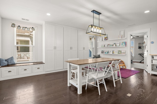 dining area featuring ceiling fan and dark hardwood / wood-style flooring