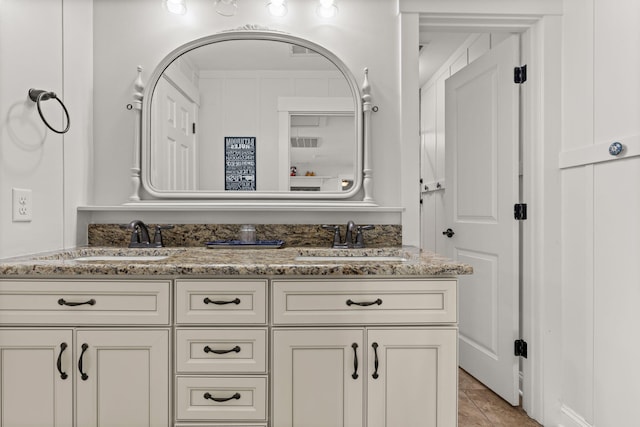 bathroom featuring tile patterned flooring and vanity